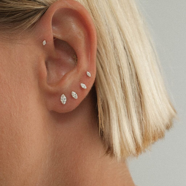 Ear styled with a row of marquise-shaped clear stone studs.