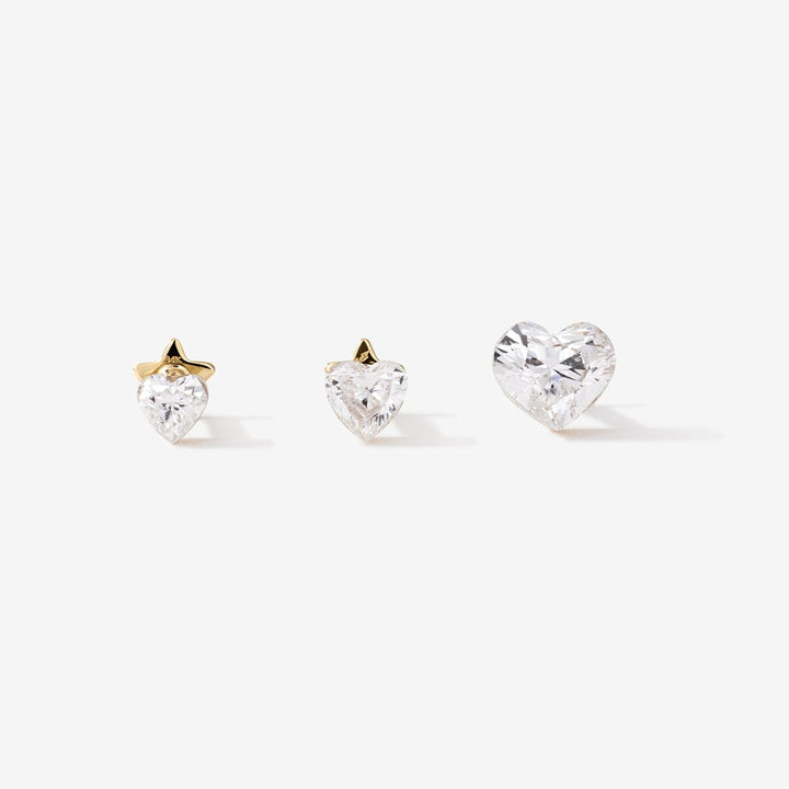 Three Clark LAB AIR™ gold heart-shaped diamond studs in different sizes.