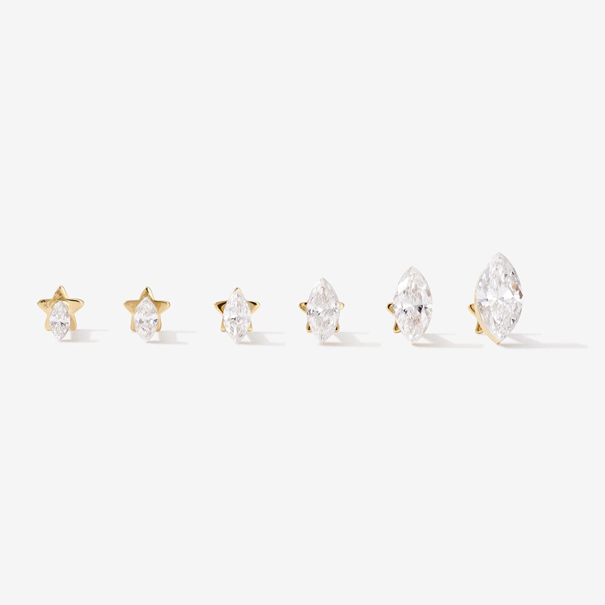 Six gold marquise-shaped lab-grown diamond studs in graduated sizes.