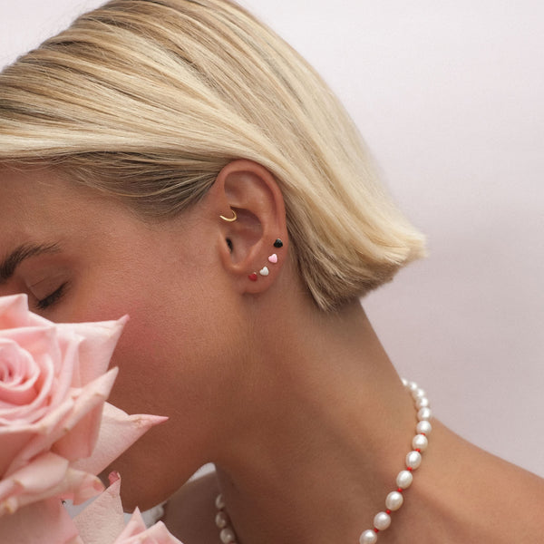 Saint pink heart piercing