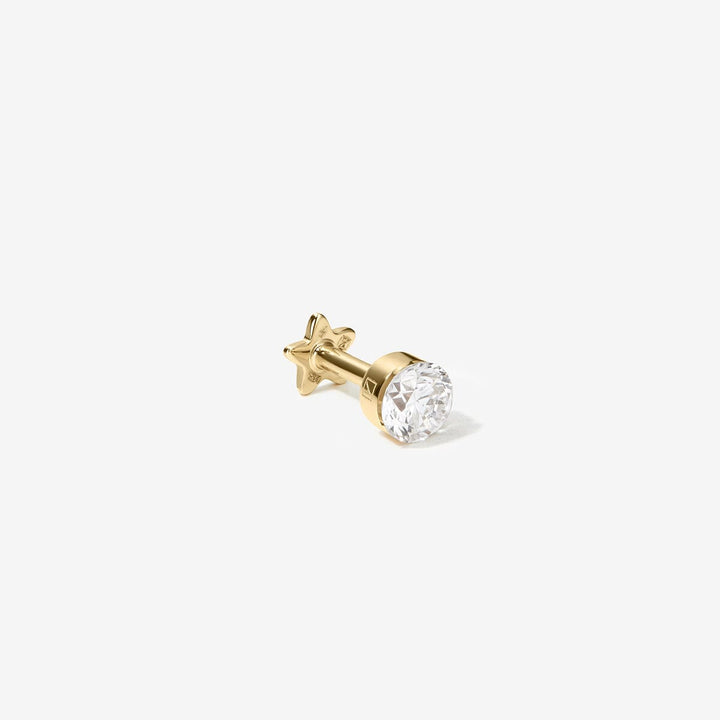 Side view of the Vince gold round diamond stud, showing its straight post and star-shaped backing.