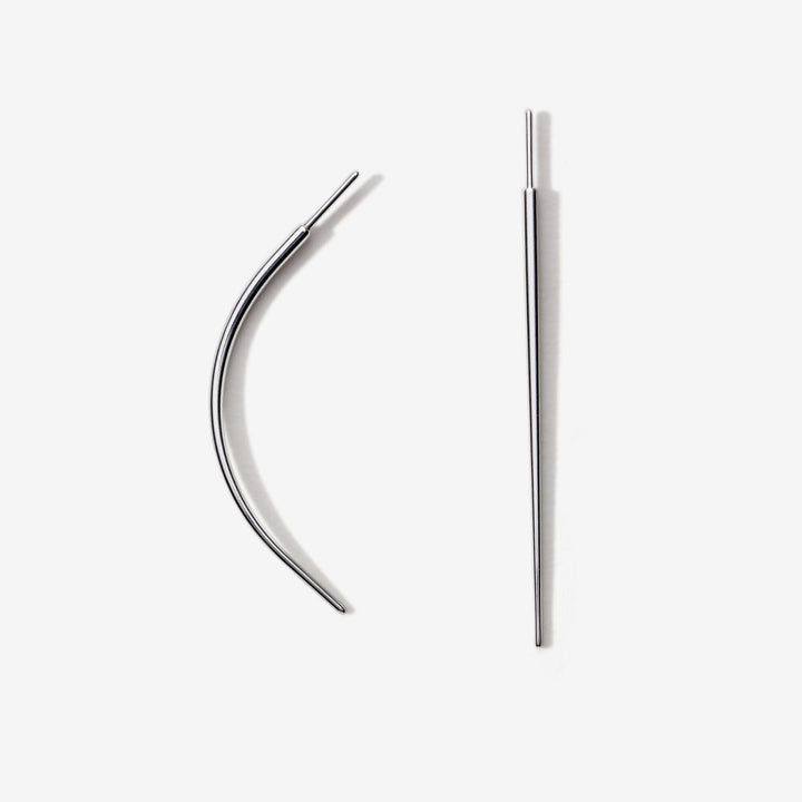 Two metal piercing tapers, one curved and one straight.